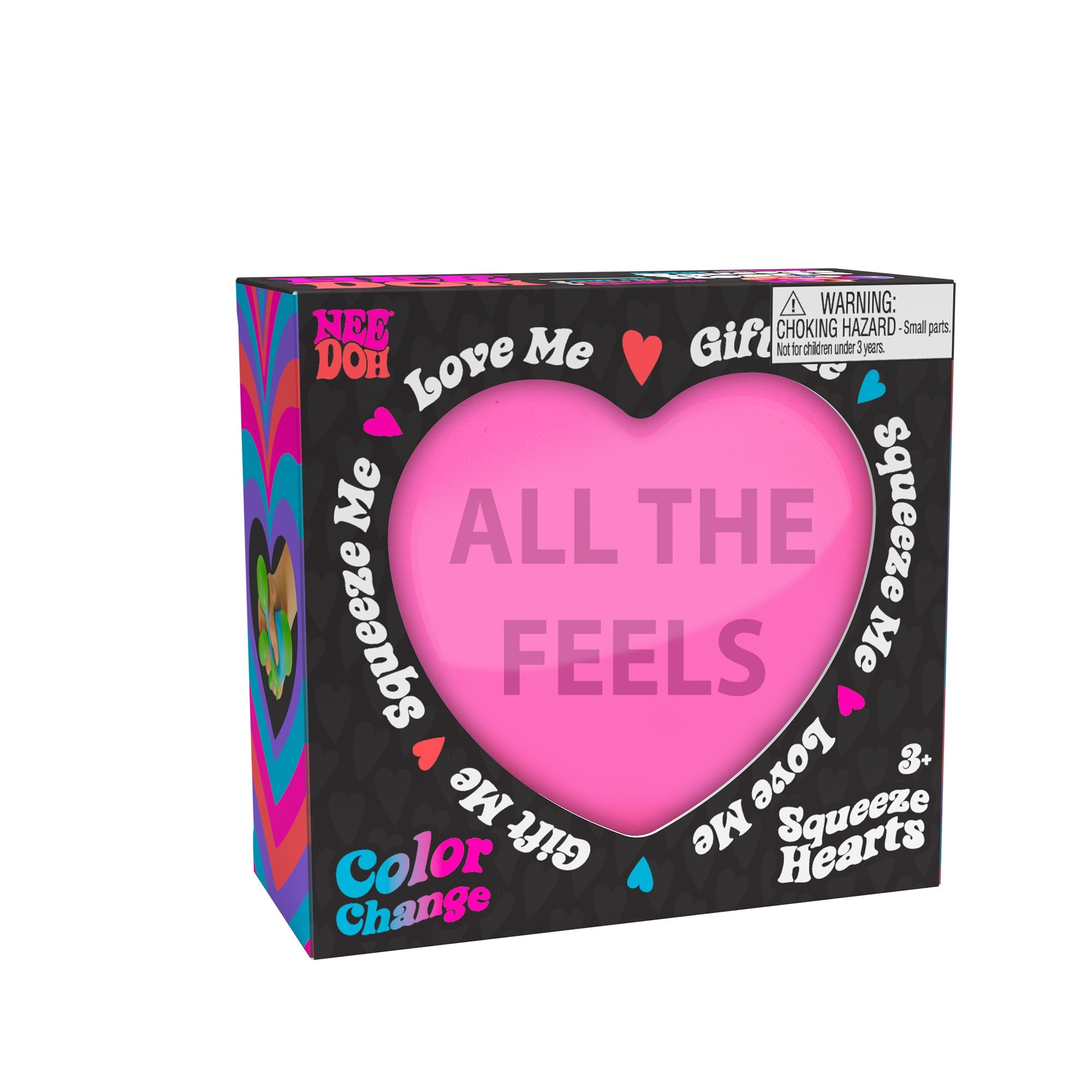 A boxed Nee Doh Color Change Squeeze Heart M9 toy. The packaging is predominantly black with colorful accents, featuring phrases like "ALL THE FEELS," "Squeeze Me," "Love Me," and "Gift Me." The box also includes a choking hazard warning for small parts.